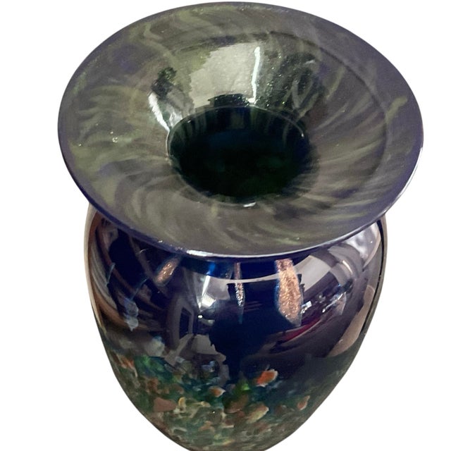 This hand blown glass vase incorporates browns, greens, and copper sparkle on a dark blue ground. I love the accents of...