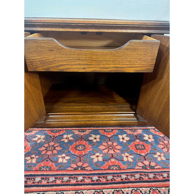 Add a touch of classic American craftsmanship to your bedroom with this elegant United Furniture Bedside Table. Carved...