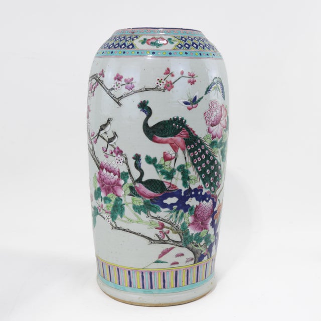 This exquisite Chinese Famille Rose porcelain palace vase features a richly detailed hand-painted design depicting an...