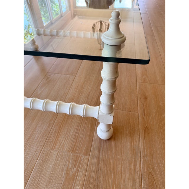 Vintage white lacquer faux bamboo - let table features a square glass and classic spindle-turned spool framing.