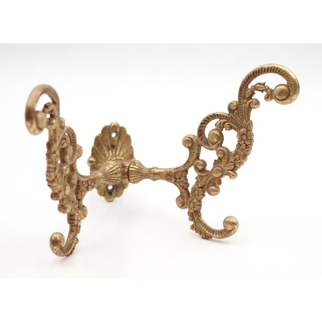 Victorian style hall tree hook made of polished brass. There is a screw attached to the back with a nut for mounting. Good...