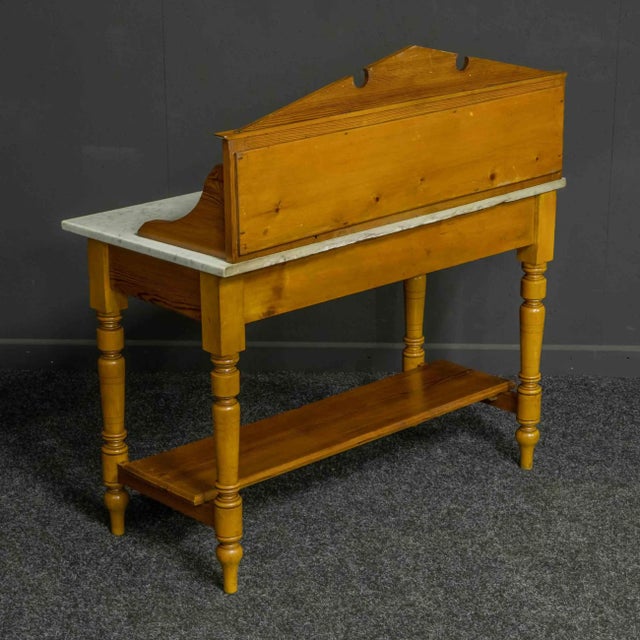 A simple yet attractive late Victorian washstand made from pitch pine and birch. Sat on four turned legs with a...