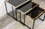 Nesting tables reminiscent of Roger Vanhevel's work in the 1970s: black lacquered metal frame, sled base, mirrored glass...