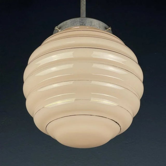Behold the exquisite vintage charm of this pink glass lamp, hailing from the artistic landscape of 1950s Italy. Its...