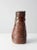 This is a vintage studio pottery vase. Signed by the artist, the playful handmade coiled pottery vase has a russet brown...