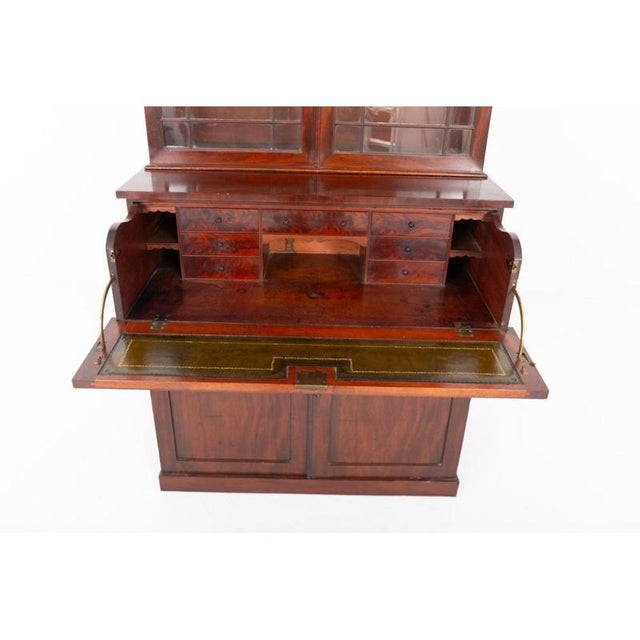 Fine william iv mahogany secretaire bookcase displaying bold architectural lines and richly figured timbers standing on a...