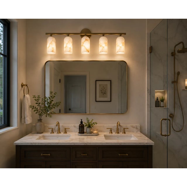 Create a sophisticated focal point with this handcrafted 5-light brass vanity sconce, featuring five natural alabaster...