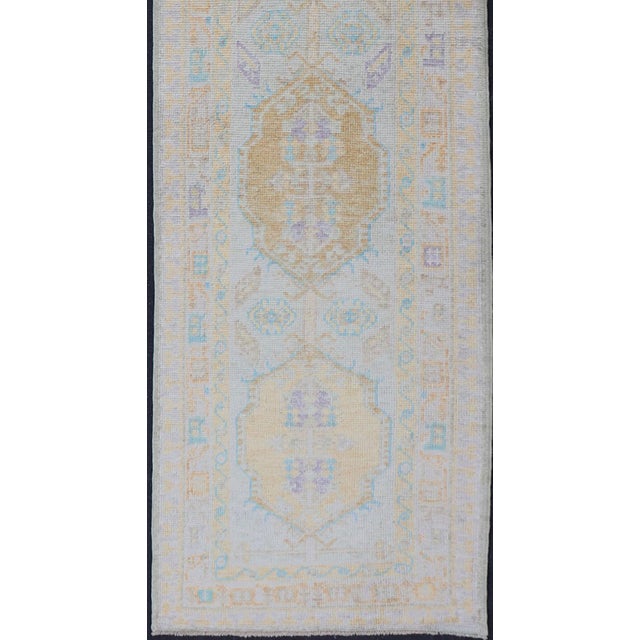 Measures: 2'8 x 13'0 Turkish Oushak Runner in Soft Pastel Blue, Gold, and Lavender 2'8 x 13'0. Keivan Woven Arts. rug...