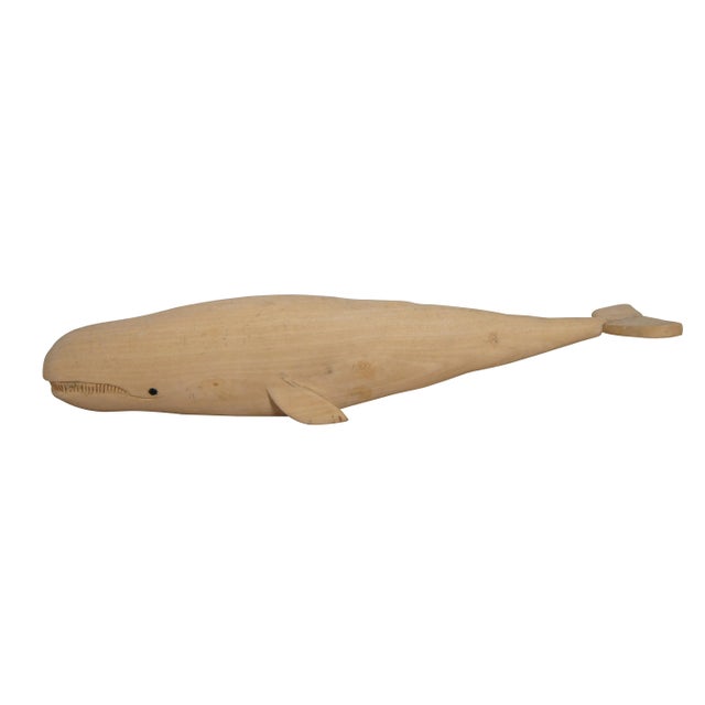 Pair of mid to late 20th century hand carved teak wood whale figurines - one sperm whale with inlaid eyes and one humpback...