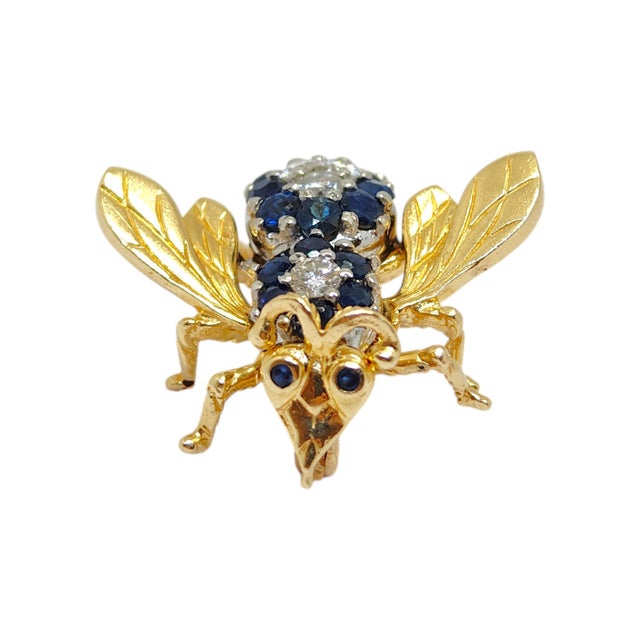 Vintage 14K yellow gold fly brooch, featuring the body embellished with round blue sapphires and brilliant white diamonds....