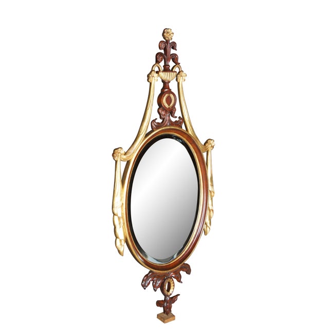 1990s Maitland-Smith Adam Style Pier Wall Mirror. Made from carved Mahogany with a parcel gilt frame. Features an oval...