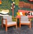Great profile and comfort on this teak club chair pair. Frames are solid teak with thick upholstered cushions and the back...