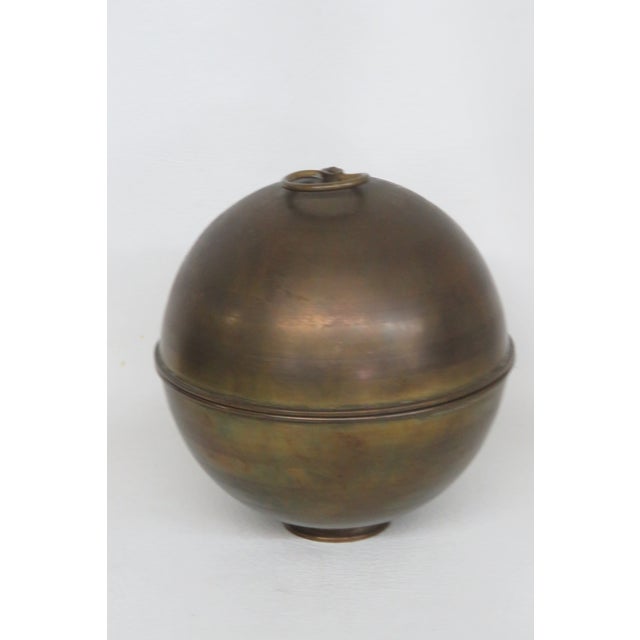 A beautiful globe-shaped Sphere cigarette dispenser from the iconic 1950s and 60s era. Made of metal and brass, Its patina...