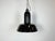 Industrial black enamel pendant light made in Germany during the 1930s. White enamel inside the shade. Cast iron top. The...