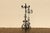 Striking early 20th-century wrought iron floor candelabra featuring seven candle holders and an elaborate hand-forged...