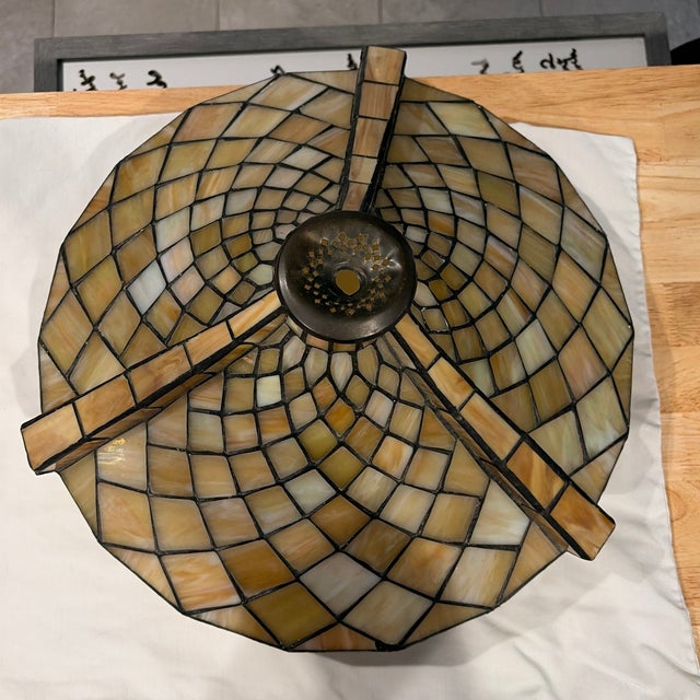 Incredible diamond shaped gold and green stained glass pieces with amber accents along the bottom rim. Raised structural...