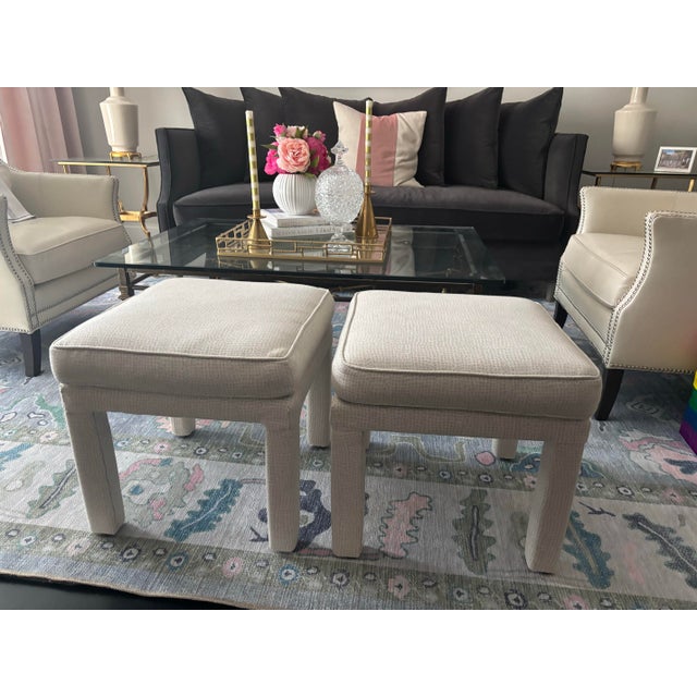 Offered is a pair of 1970s upholstered ottomans that have been professionally reupholstered and a lovely neutral grayish...