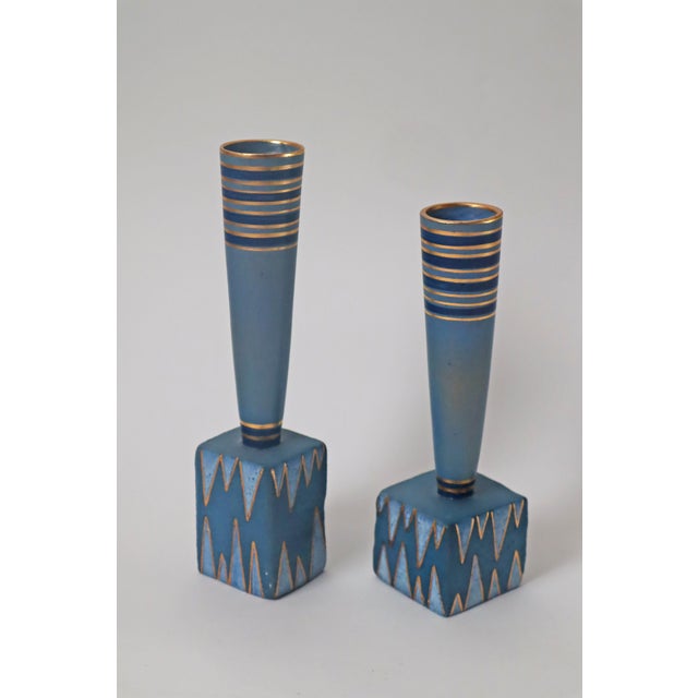 The slightly larger vase has a height of 29cm and a width and depth of 7.5cm, the smaller vase is 25.5cm and a width of...