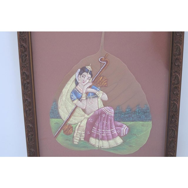Vintage framed Indian painting meticulously handcrafted on a real skeleton Peepal tree or fig leaf. The artwork depicts a...