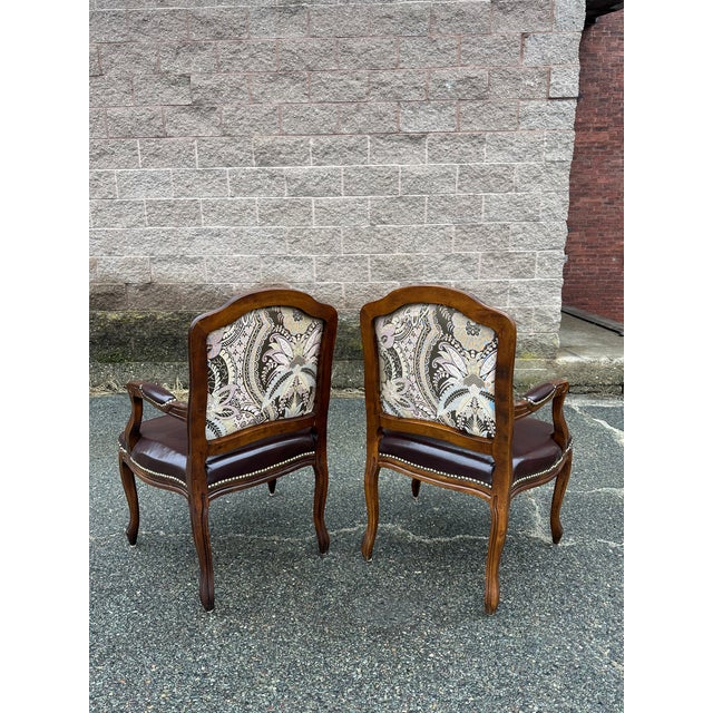 Beautiful vintage pair of armchairs with detailed needlepoint upholstery on both sides of the backrest, faux leather seats...