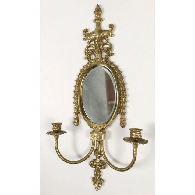 Classic Pagoda or Empire style mirrored wall candle sconce of heavy brass. Holds two taper candles. Lovely patina. No...