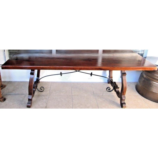 This Vintage Spanish Catalan Trestle Dining Table with Lyre Legs and Iron Stretchers is a unique and stylish piece of...