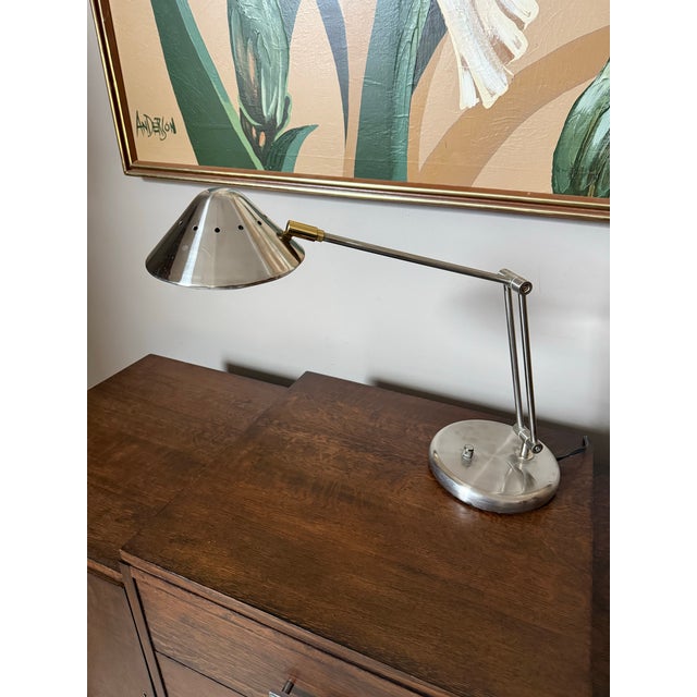 Vintage retro UFO saucer style lamp. The lamp is dimmable and adjustable/articulating. Color is nickel.