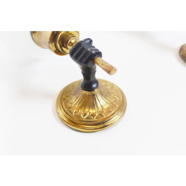 High-quality set of brass wall lamps in the style of Maison Jansen. Typical French elegance from the 1950s. Both are in...