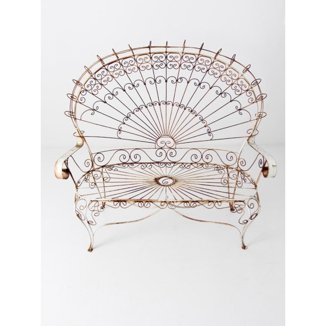 This impressive vintage wrought iron peacock set, in the Salterini style, features two chairs, a settee, and coffee table....