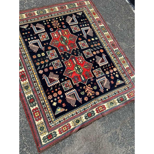 A striking antique Kazak rug distinguished by its bold geometry and timeless tribal character. Woven circa 1920s, this...