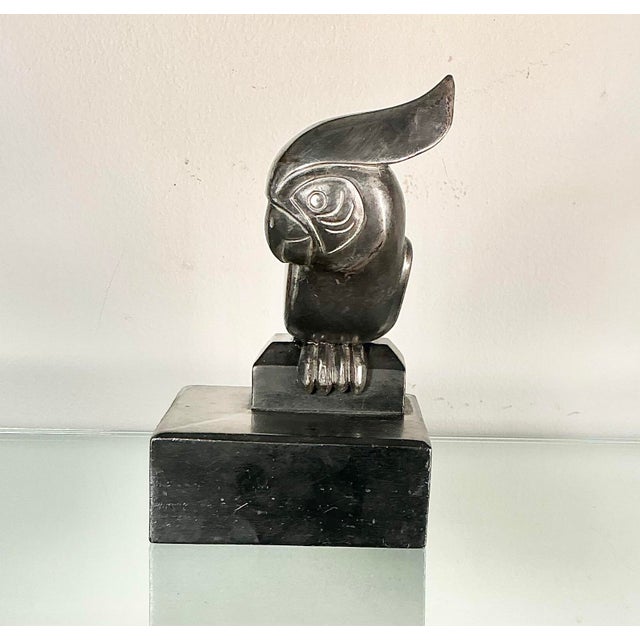 High-quality vintage Spelter metal sculpture of a cockatoo, designed in an Art Deco style and mounted on a tiered black...