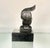 High-quality vintage Spelter metal sculpture of a cockatoo, designed in an Art Deco style and mounted on a tiered black...