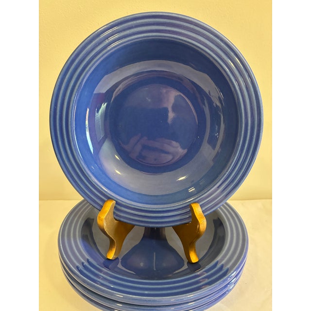 A striking set of four vintage Emile Henry ceramic bowls made in France. The bowls feature a rich cobalt blue glaze with...