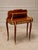 Elegant French Louis XV-style writing table featuring a distinctive double-tier construction, richly figured wood and...