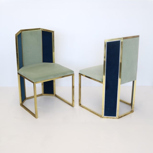 Set of six brass framed upholstered dining chairs with contrasting upholstered panel backs. The upholstery is featured to...
