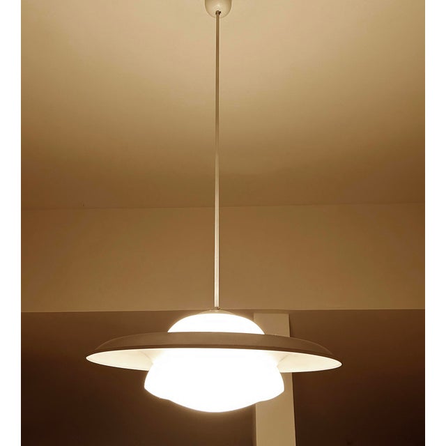 Exceptionnal set of 2 very large bauhaus pendant lights featuring an opaline glass shade on which a large sombrero style...