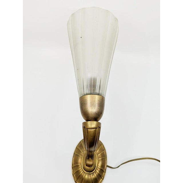 This classic pair of sconces was manufactured in Italy around 1930. They are made of a sandblasted and "costolonato"...