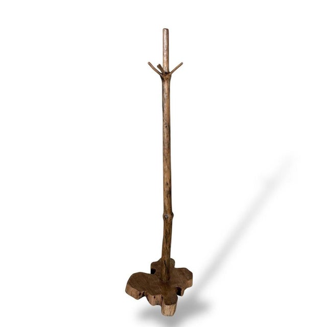 A striking live edge solid wood coat stand crafted from natural timber, celebrating the organic beauty of the tree itself....