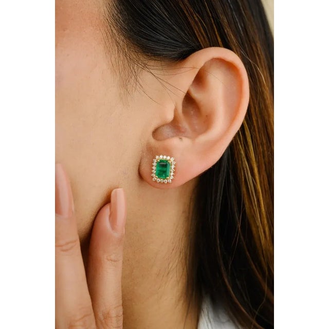 This is part of Chairish’s Fine Jewelry assortment. Certified Emerald Halo Diamond Stud Earrings in 18K Gold to make a...