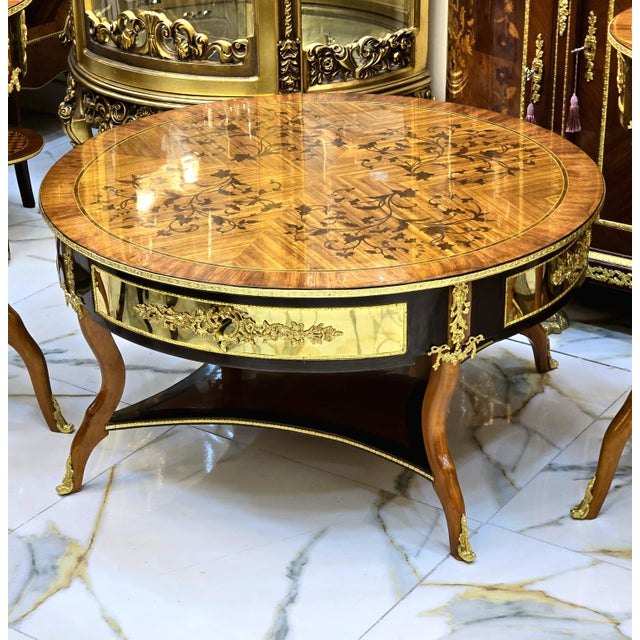 Elevate your living room with this exceptional French Louis XV-inspired coffee table, featuring an elegant oval...