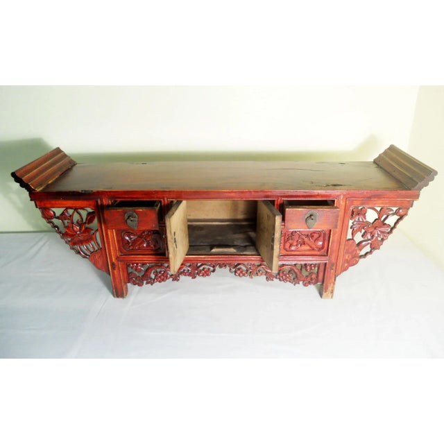 This antique Chinese petit Altar is circa early of 19th century. Intricate carvings of "lotus flower" design decorate the...