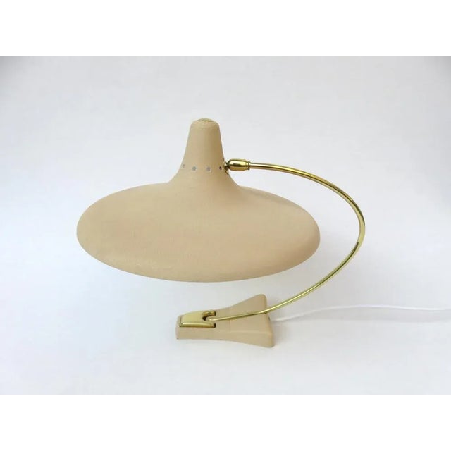 An unusual table lamp with witch hat shade from the 50s, made in Germany. The lamp arm and push button switch are made of...