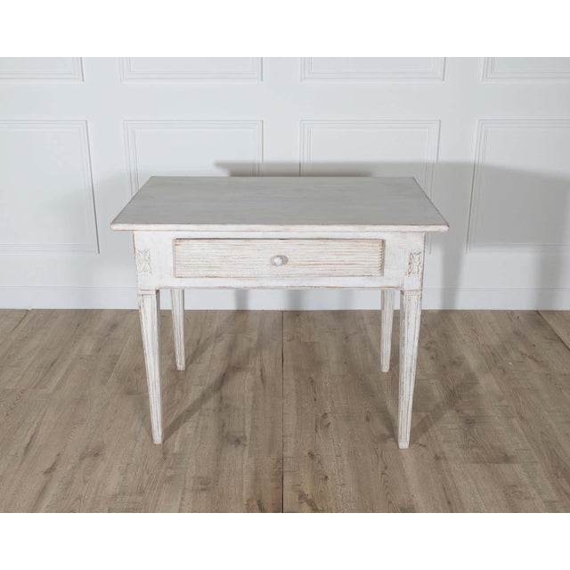 A graceful Swedish table dating to circa 1850, crafted in the Gustavian style and retaining its original painted finish....