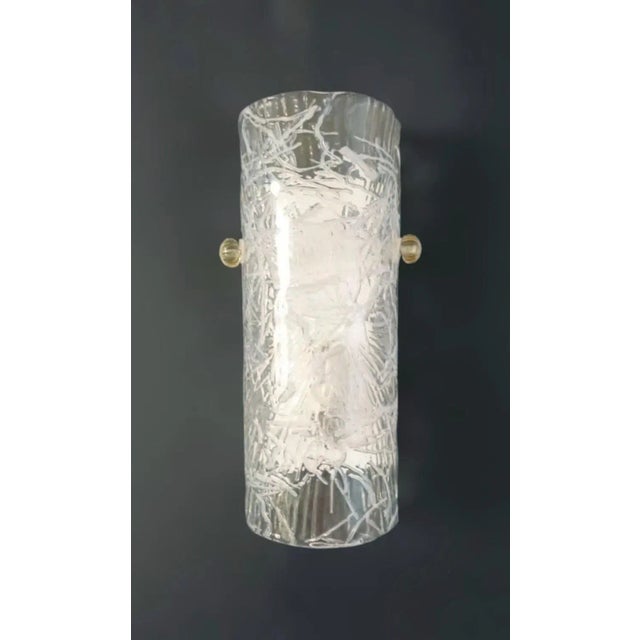 Italian wall light with a cylinder Murano glass shade in clear color with white texture, mounted on white metal frame /...