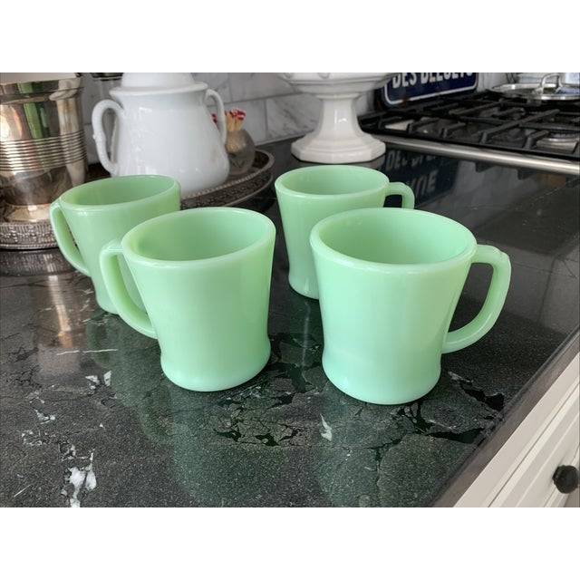 Here we have set of four vintage Fire King Jadeite mugs. These beautiful mugs are in excellent condition with no damage,...