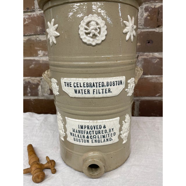 This English 19th century water filter was manufactured by Walker and Company in Boston, England and is earthenware with a...