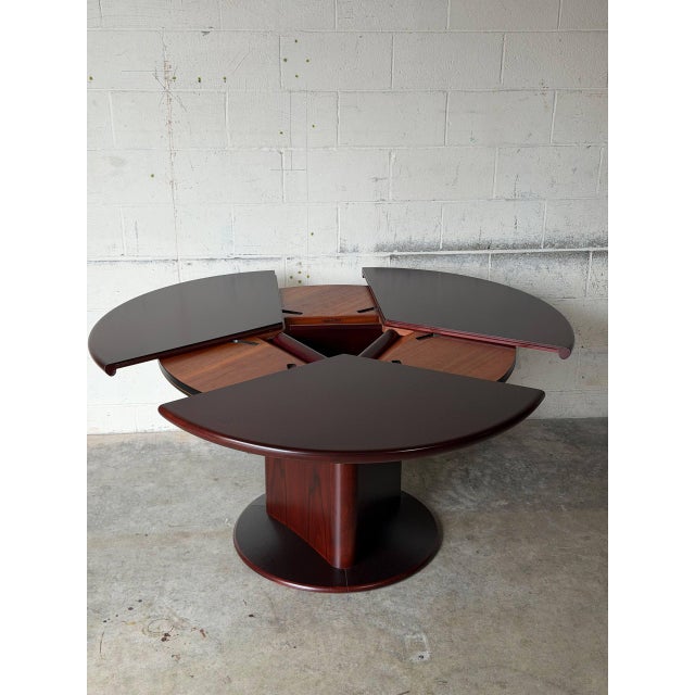 Featuring an iconic circular design, this table expands effortlessly with its patented clever butterfly extension...