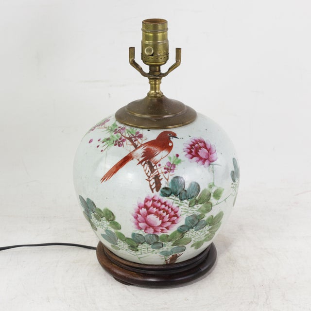 This antique table lamp is crafted from an authentic porcelain vase featuring the vibrant Famille Rose palette. The...