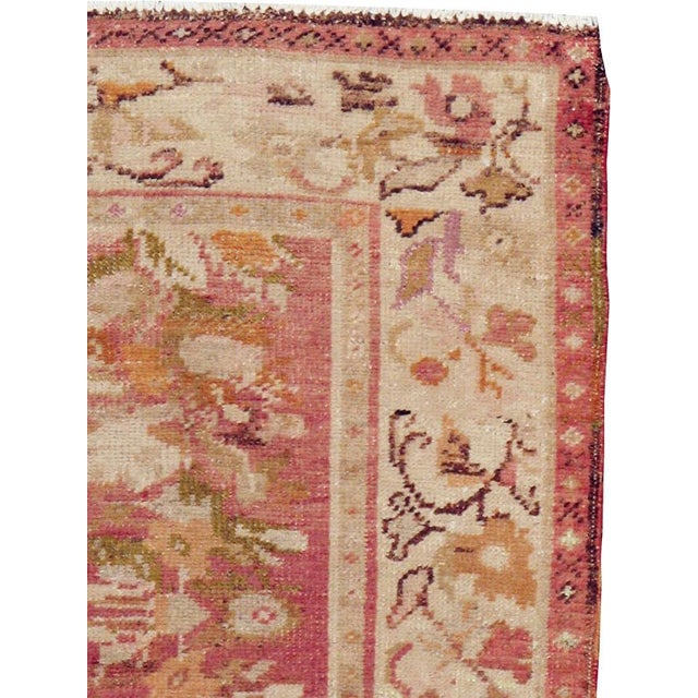 This early 20th century Turkish Oushak throw rug, measuring 2' 10" x 5' 6", showcases a graceful column of stylized floral...