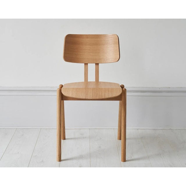 Inspired by the classic stacking mid-century school chair, this stackable dining chair handmade in European oak is...